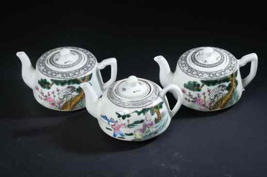 Appraisal: THREE CHINESE FAMILLE ROSE PORCELAIN TEA POTS Each with iron