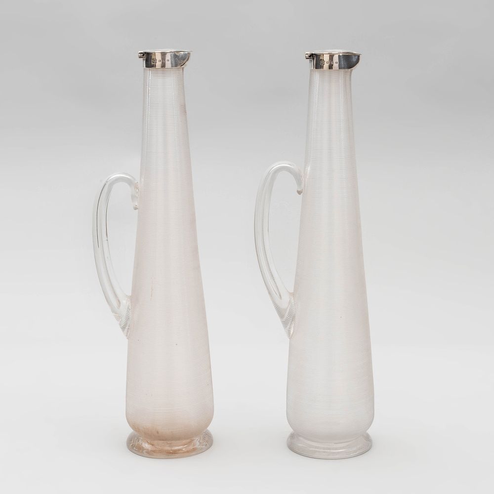 Appraisal: Pair of Victorian Silver-Mounted Ribbed Glass Claret Jugs After a