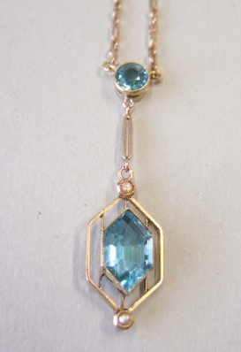 Appraisal: A gold half pearl and pale blue gem set pendant