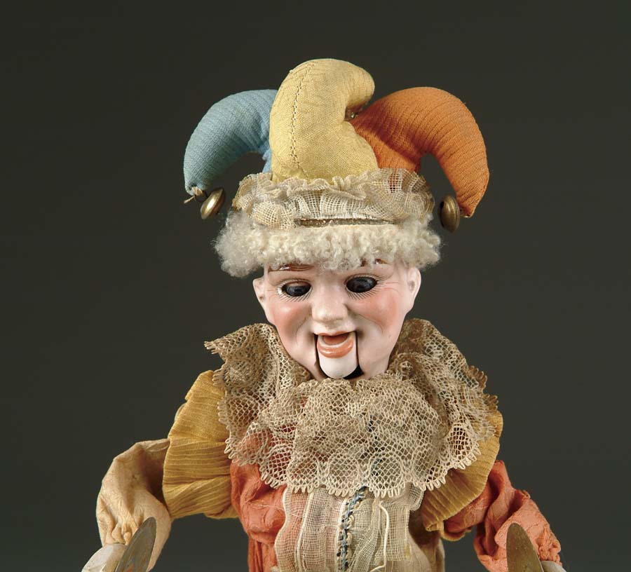 Appraisal: BISQUE HEAD JESTER MECHANICAL TOY Unusual bisque character head incised