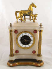 Appraisal: An alabaster and gilt metal cased mantel clock with visible