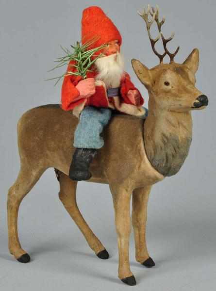 Appraisal: Santa Riding Composition Reindeer Candy Container Description Glass eyes and