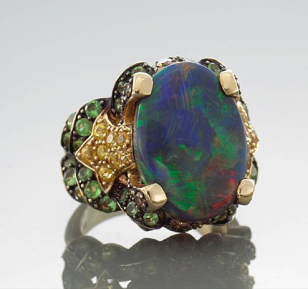 Appraisal: An opal sapphire and diamond ring centering an oval-shaped opal