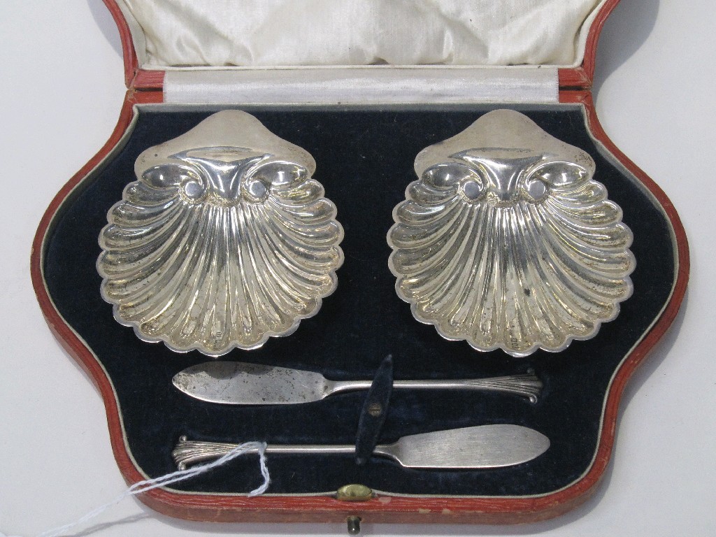 Appraisal: Cased pair of silver shell shaped butter dishes with servers