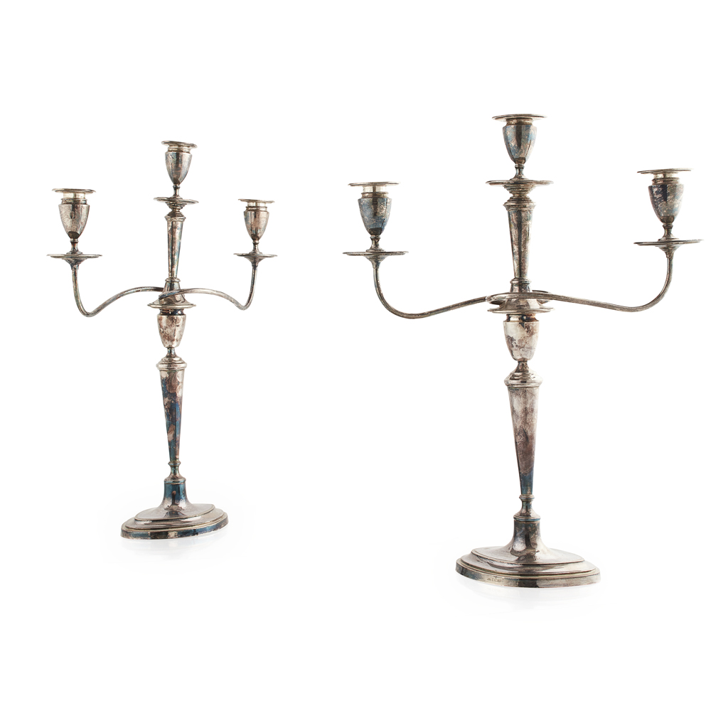 Appraisal: A pair of Edwardian three light table candelabra Sheffield of