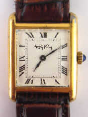 Appraisal: A tank shaped gold plated silver watch Roy King fully