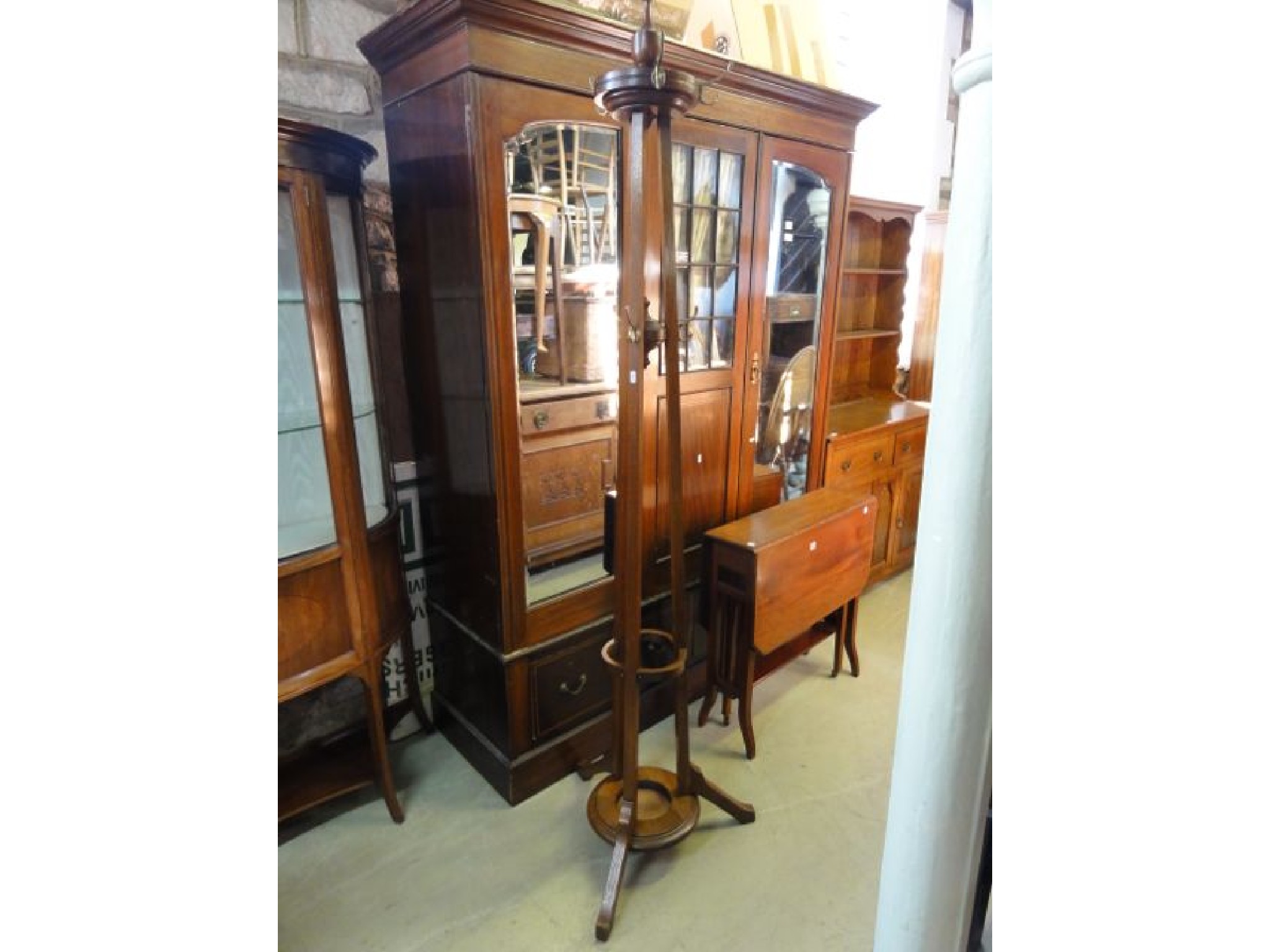 Appraisal: An Edwardian oak freestanding hat coat stand the central turned