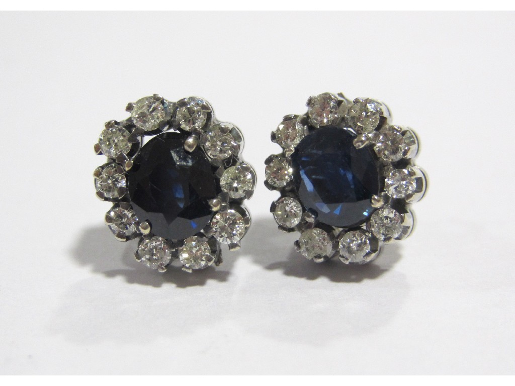 Appraisal: A pair of white metal sapphire and diamond set stud