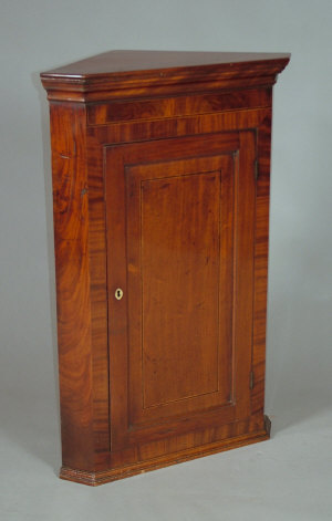 Appraisal: A George III mahogany and inlaid corner cupboard the ogee