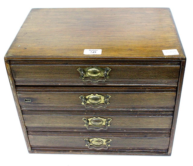 Appraisal: A MAHOGANY CASED FOUR DRAWER MINIATURE CHEST OF DRAWERS with