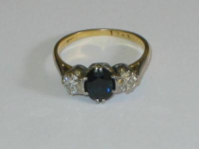 Appraisal: A SAPPHIRE AND DIAMOND THREE STONE RING the central oval