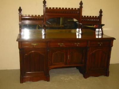 Appraisal: A VICTORIAN WALNUT PEDESTAL SIDEBOARD the raised and stepped mirrored