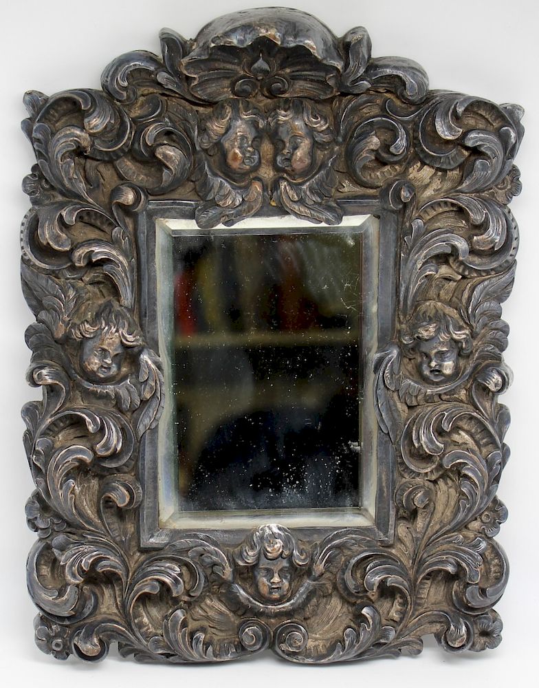 Appraisal: High Relief Mirror with Putti High relief frame with shell