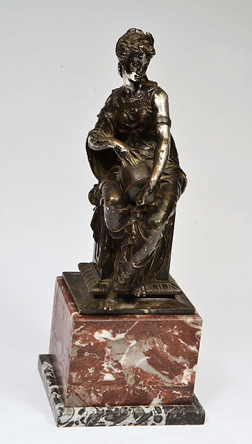 Appraisal: A CAST SILVERED STATUE of a river goddess seated on