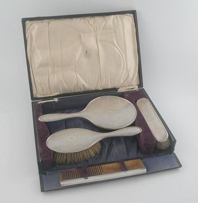 Appraisal: A modern mounted dressing table set comprising two brushes comb