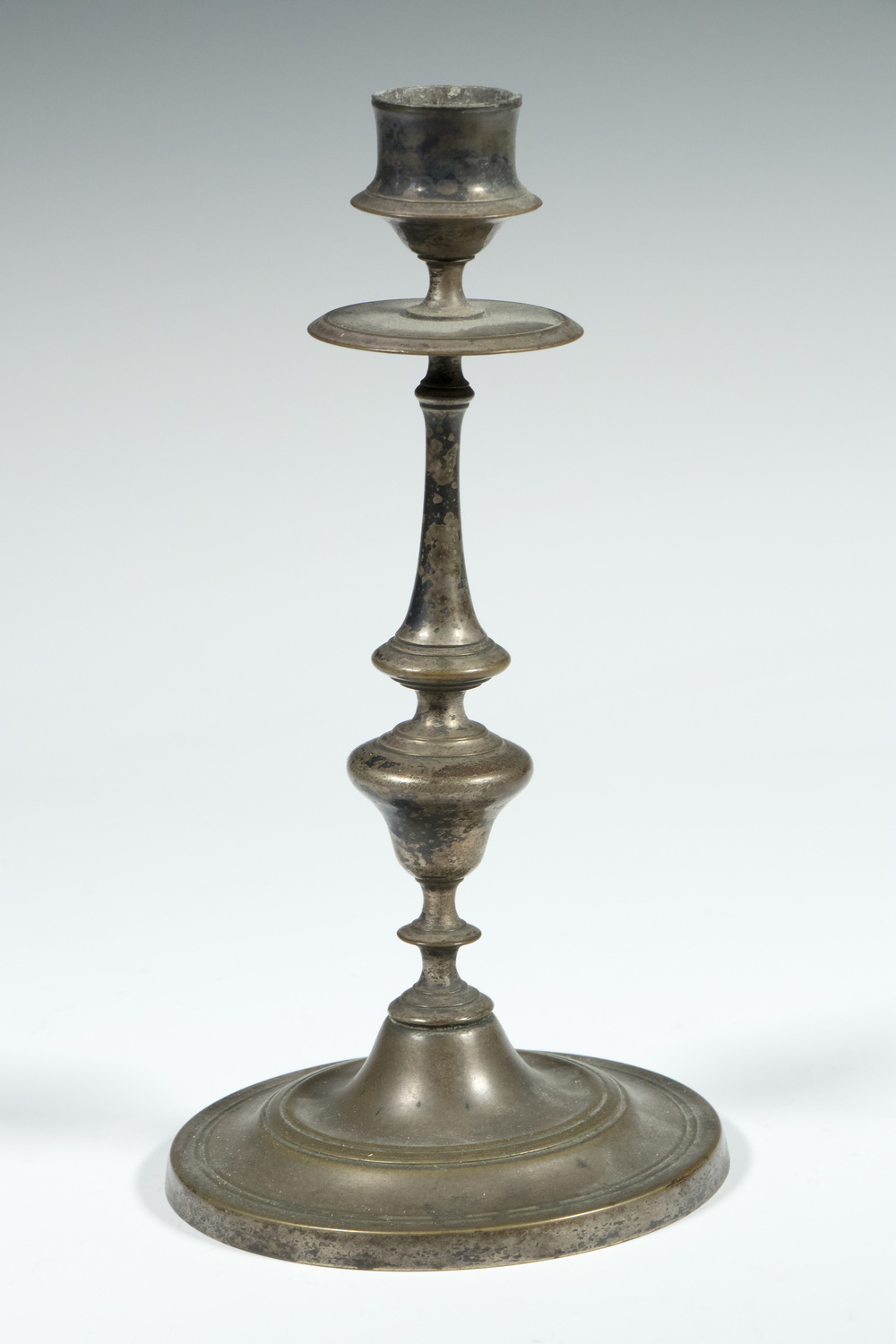 Appraisal: CONTINENTAL SILVER-PLATE CANDLESTICK th c Silver on Brass Candle Holder