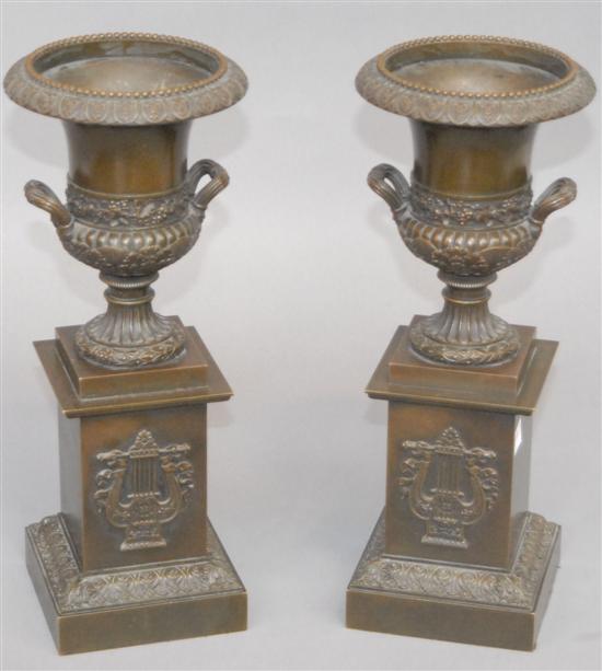 Appraisal: PAIR TH C BRONZE URNS Repousse with lyre decoration in