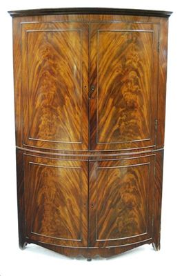 Appraisal: A George III mahogany bowfront standing corner cupboard the moulded