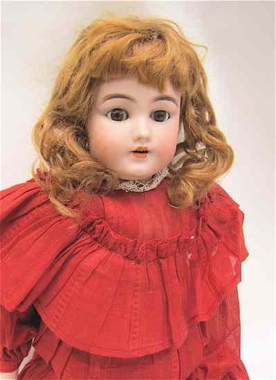 Appraisal: GERMAN BISQUE HEAD DOLL auburn wig brown glass sleep eyes