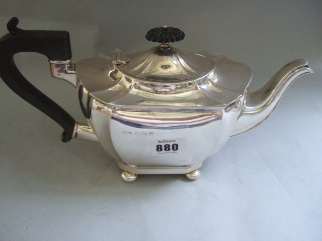 Appraisal: A silver teapot of panelled form with black fittings and