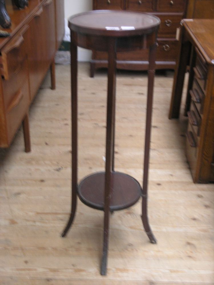 Appraisal: An Edwardian mahogany plant stand circular shape with undertier ft