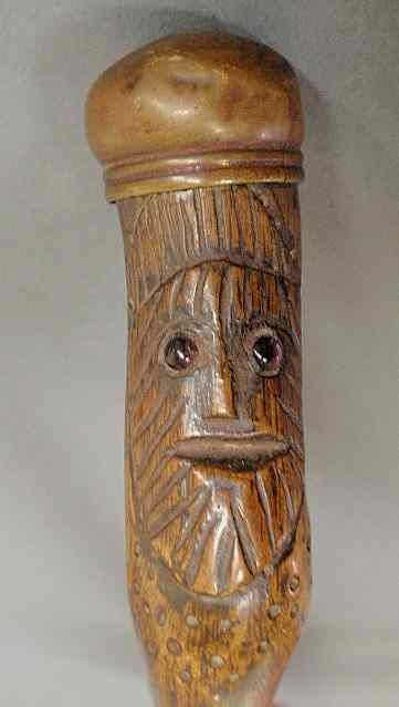 Appraisal: Walking stick late th c the handle with a carved