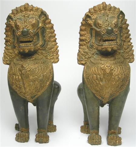 Appraisal: A pair of South East Asian giltmetal and stone lions