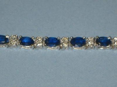 Appraisal: A SAPPHIRE AND DIAMOND BRACELET the oval cut sapphire claw