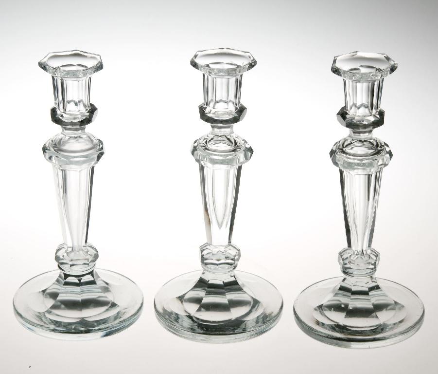 Appraisal: SET OF THREE EDWARDIAN CUT-GLASS COLUMNAR CANDLESTICKS each with tapering