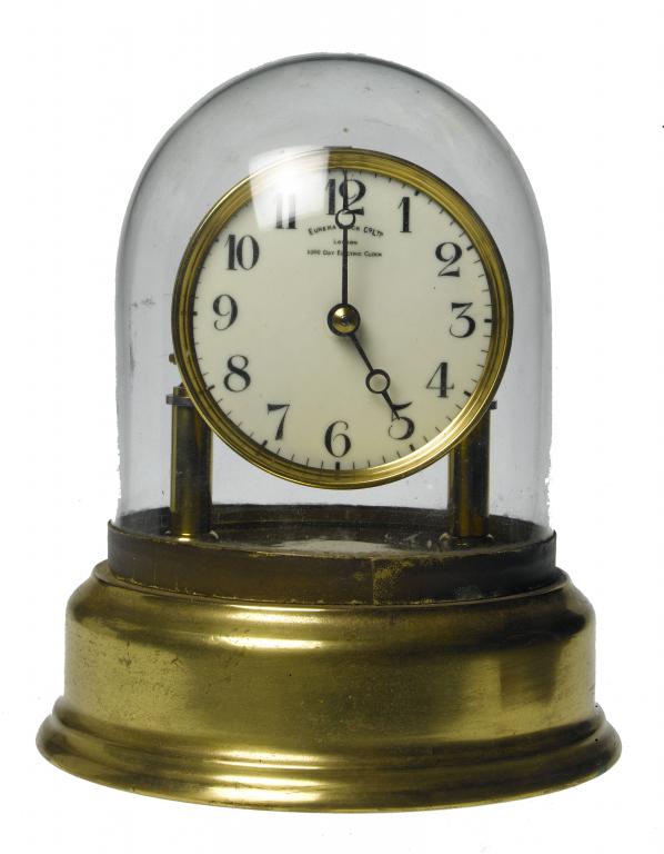 Appraisal: A BRASS ELECTRIC TIMEPIECE the enamelled dial signed EUREKA CLOCK