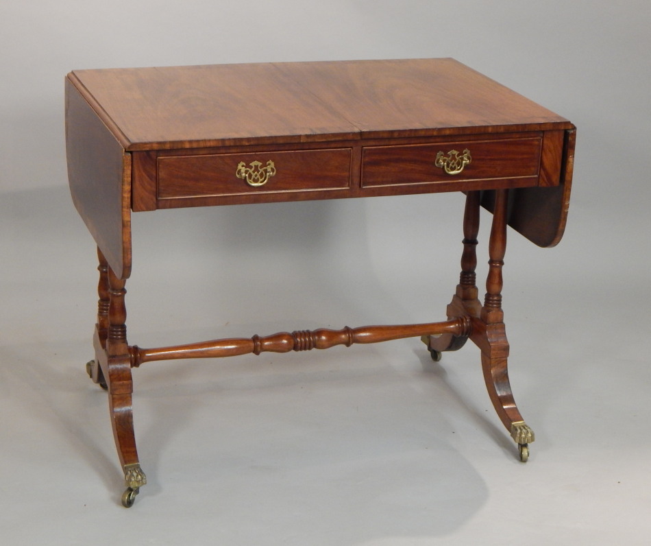 Appraisal: A Regency style mahogany sofa table the top with a