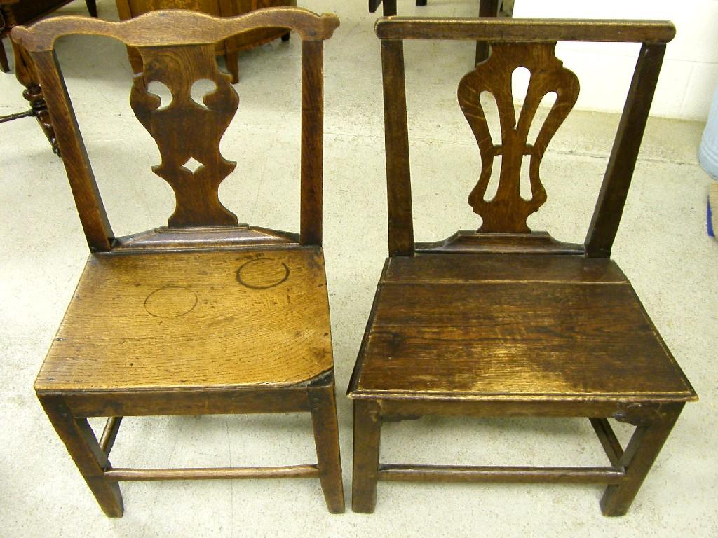 Appraisal: Two Georgian oak hall chairs with pierced vertical vase splats