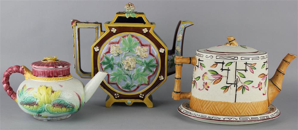 Appraisal: THREE VICTORIAN TEAPOTS AND COVERS including a majolica flat blue-ground