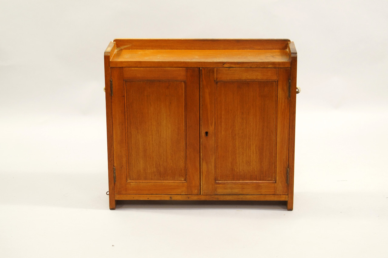 Appraisal: A mahogany wall cabinet early thC two doors enclosing a