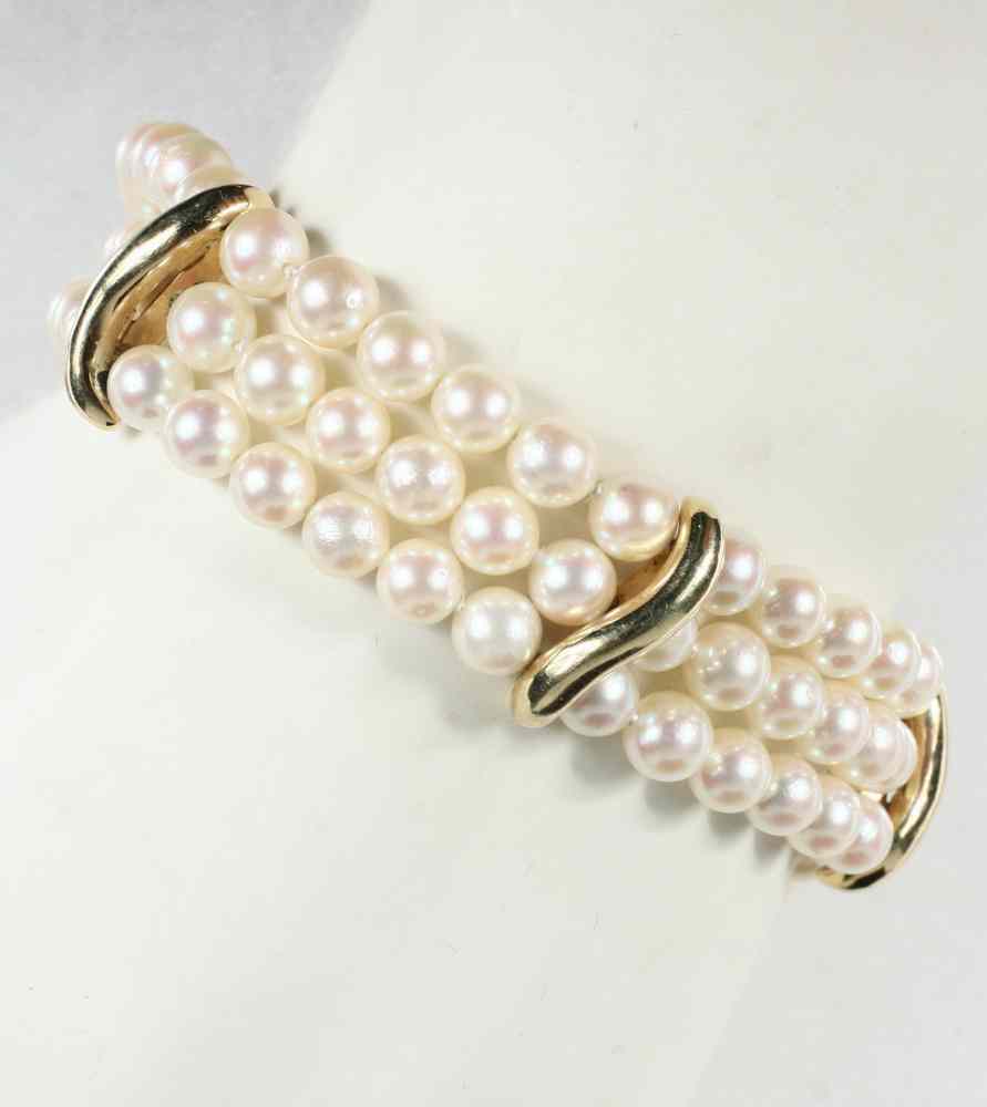 Appraisal: BRACELET - Triple strand of mm pearls with gold bar