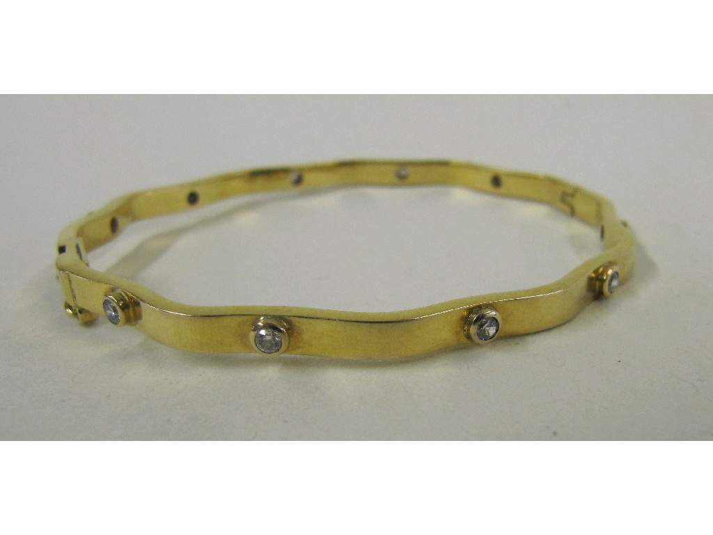 Appraisal: Yellow metal gem set bangle