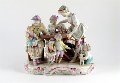 Appraisal: A French porcelain group of a family taking tea raised