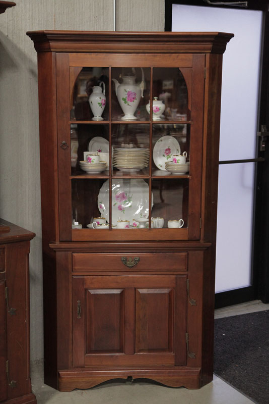 Appraisal: CORNER CUPBOARD Monitor Furniture Co Cherry having a stepped cornice