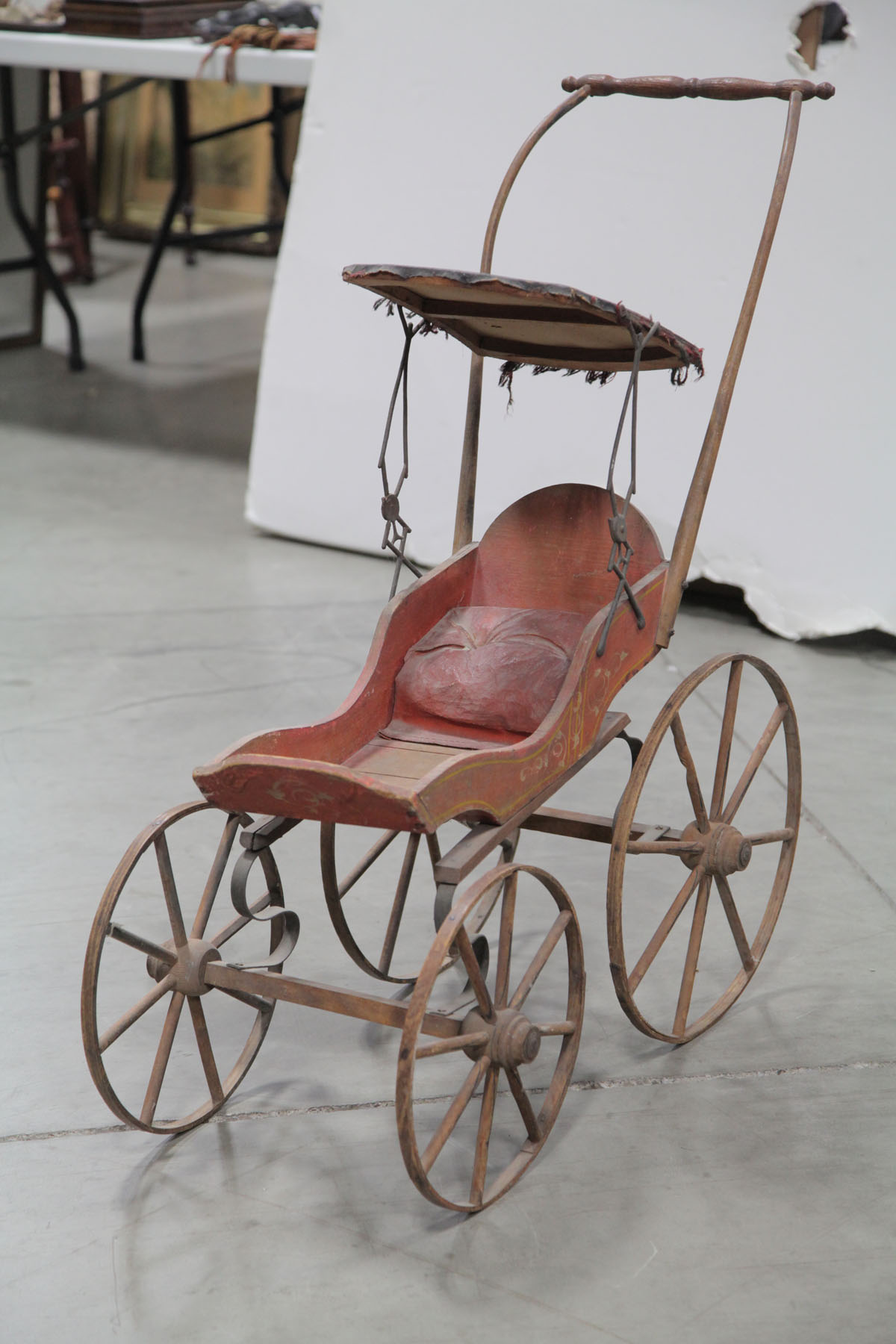 Appraisal: WOODEN DOLL BUGGY American early th century Orange painted buggy