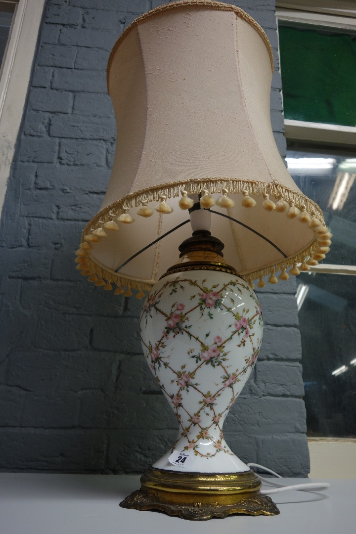 Appraisal: A French gilt metal mounted white opaline glass oil lamp