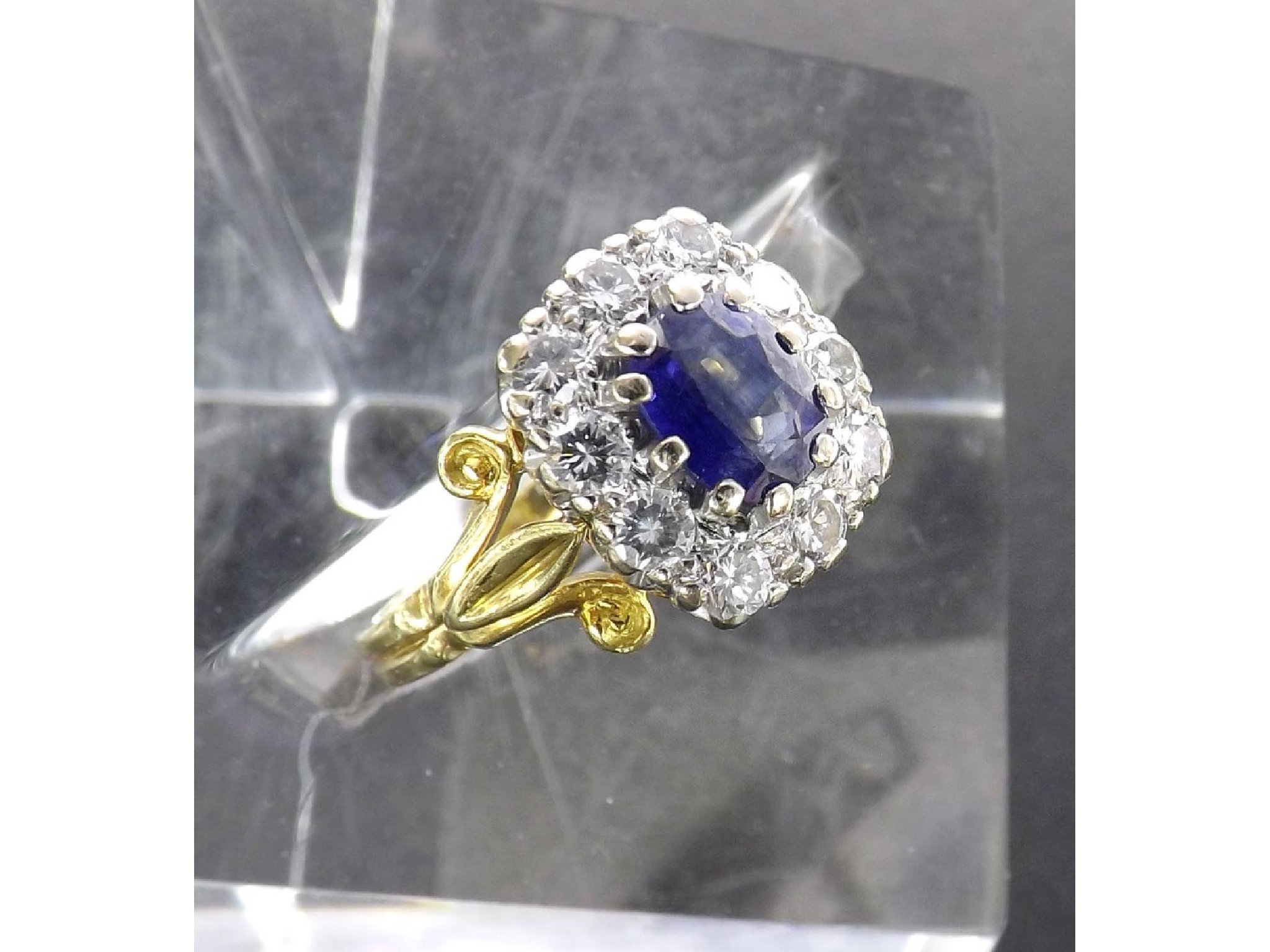 Appraisal: Good ct sapphire and diamond oval cluster ring the central