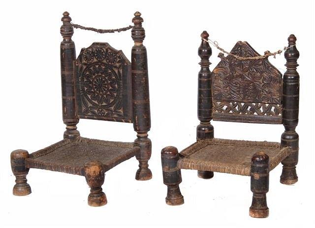 Appraisal: TWO ANTIQUE PERSIAN CARVED WOOD LOW CHAIRS stylised geometric panel