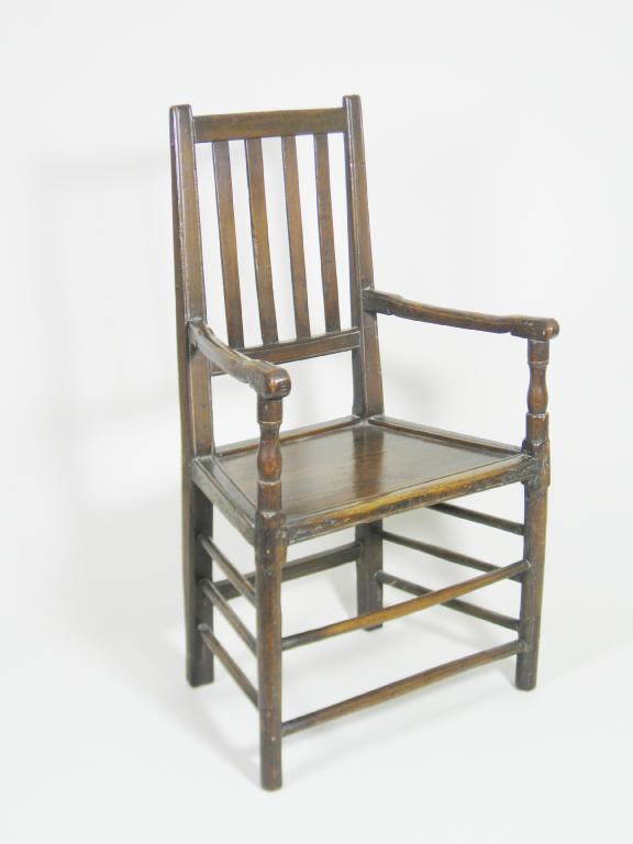 Appraisal: An antique oak Armchair slat back solid seat on turned