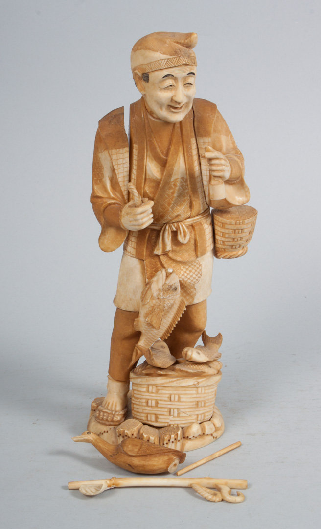 Appraisal: Japanese carved ivory fish seller modeled as man with basket