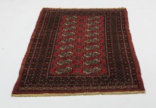 Appraisal: Hand-knotted Boukhara rug executed in wool centering two rows of