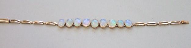 Appraisal: A gold and opal set bar link bracelet mounted with