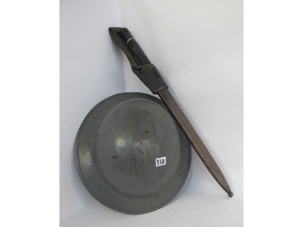 Appraisal: Lot comprising steel helmet and a bayonet in scabbard