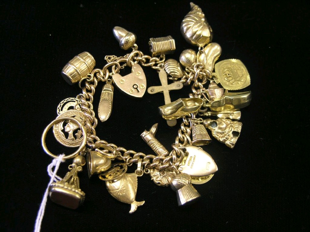 Appraisal: A ct gold charm bracelet twenty-six charms charms vary between