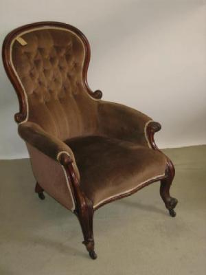 Appraisal: A VICTORIAN WALNUT ARMCHAIR of spoon back form button upholstered