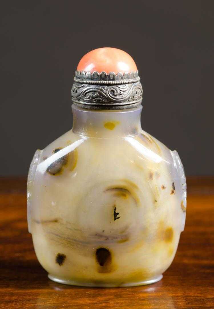 Appraisal: CHINESE CARVED AGATE SNUFF BOTTLE of compressed form with carved